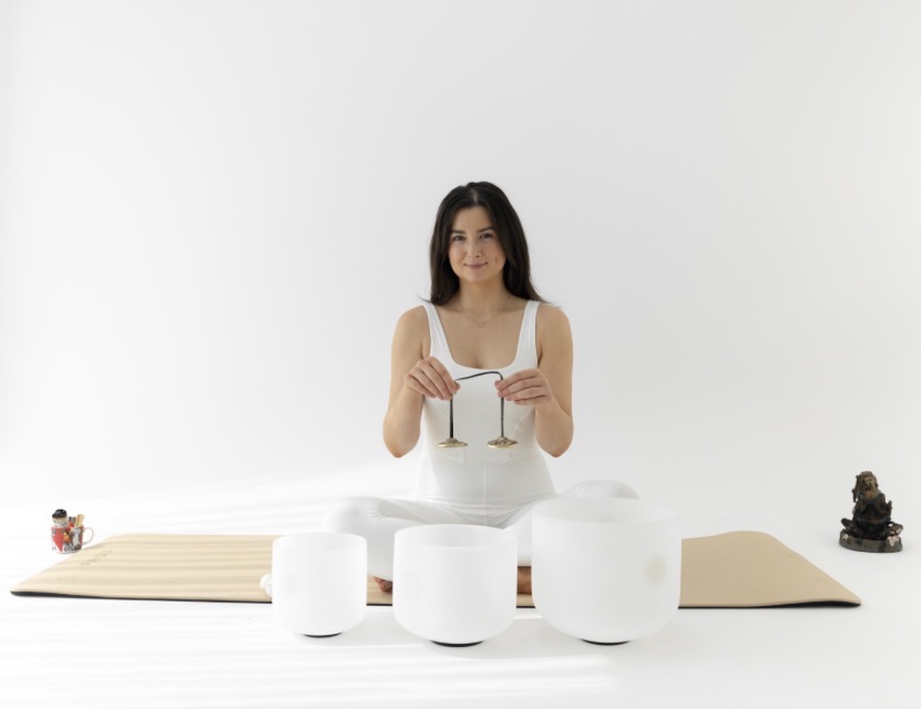 Melissa Tarpey seated with chimes and crystal singing bowls
